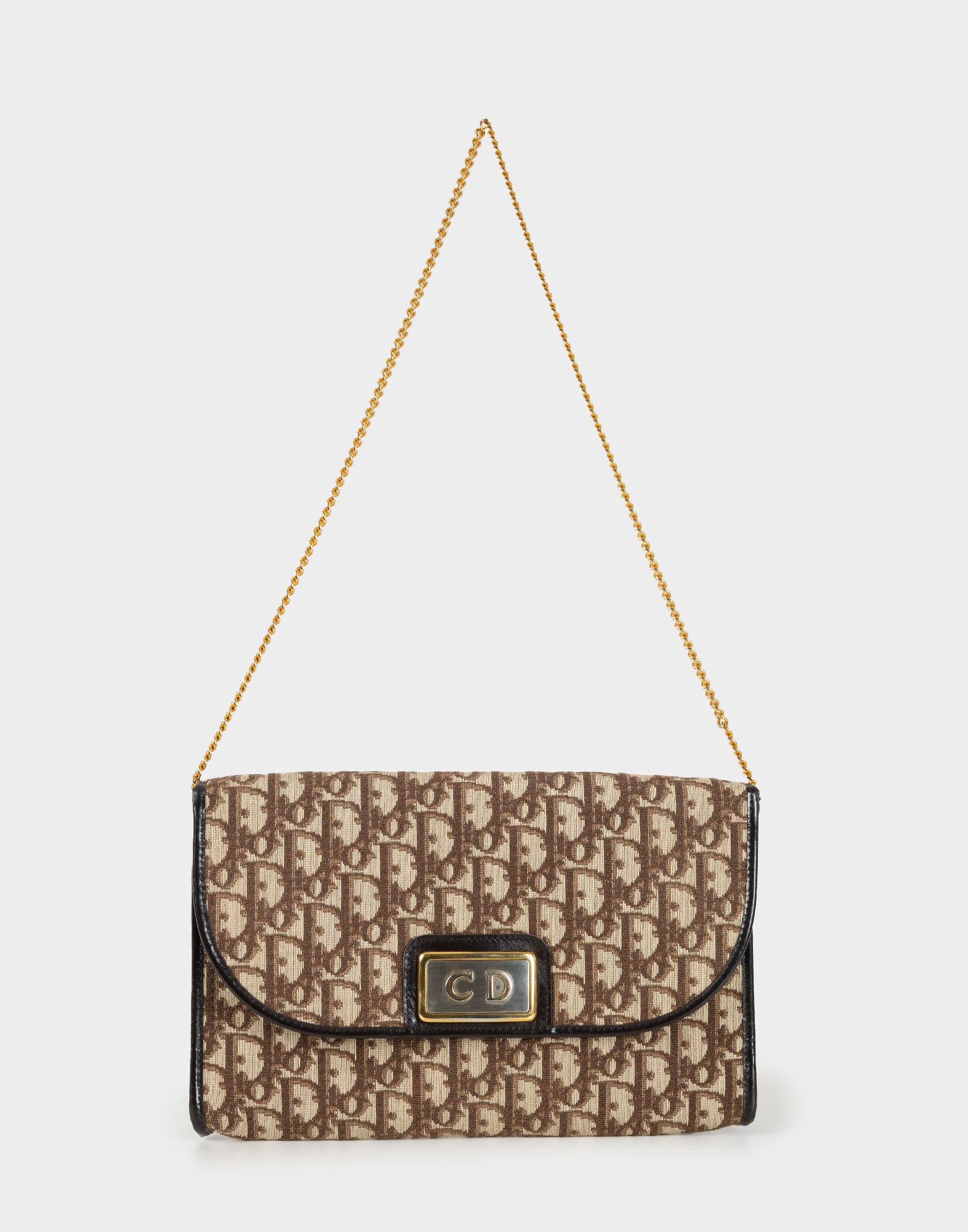 beige and brown fabric clutch handbag with monogram pattern and gold chain