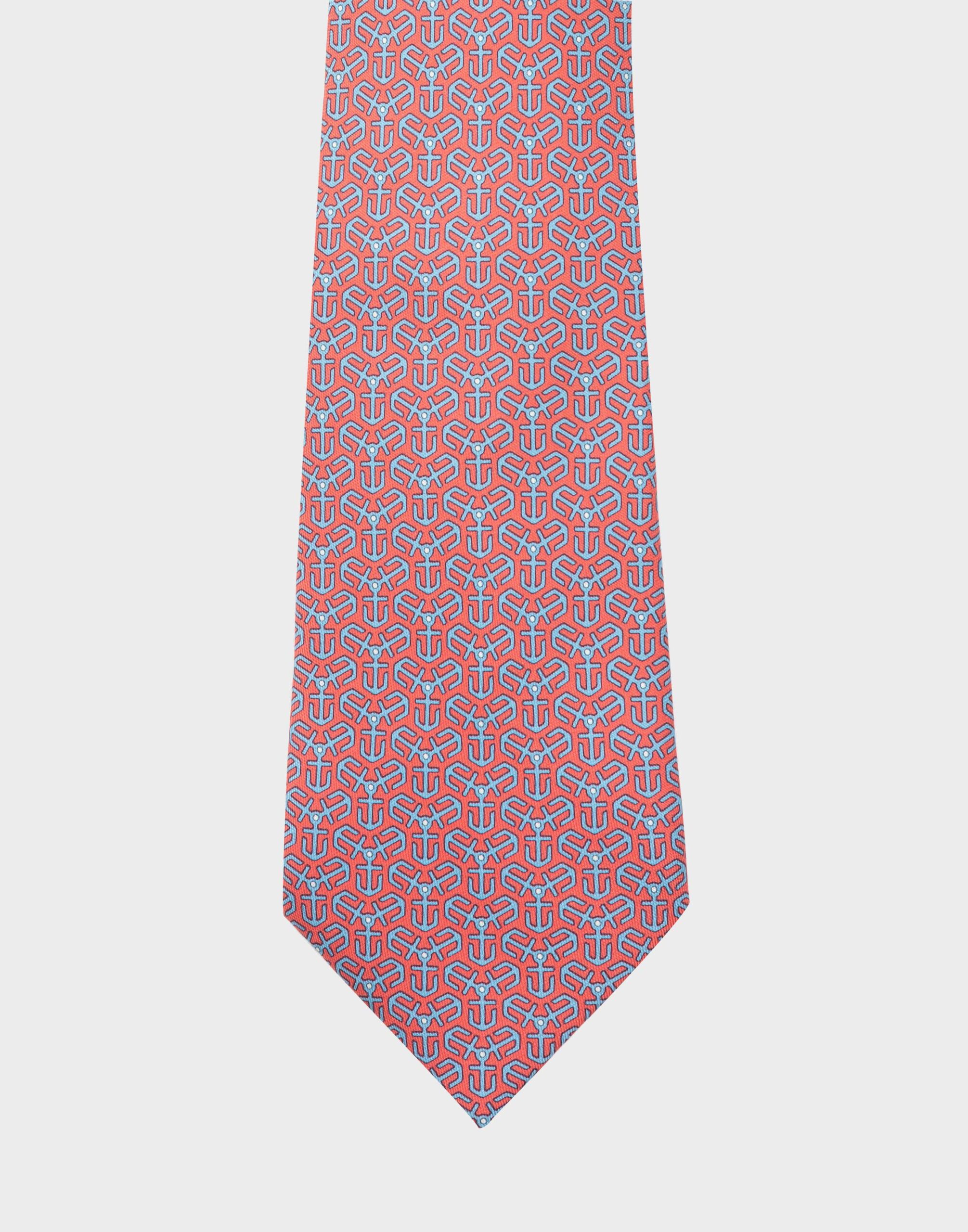 Coral tie in 100% silk with an all-over pattern of blue anchors