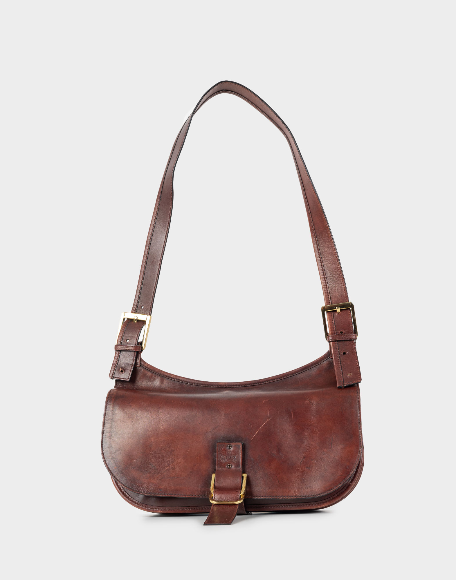 Dark brown leather Gucci bag with shoulder strap.