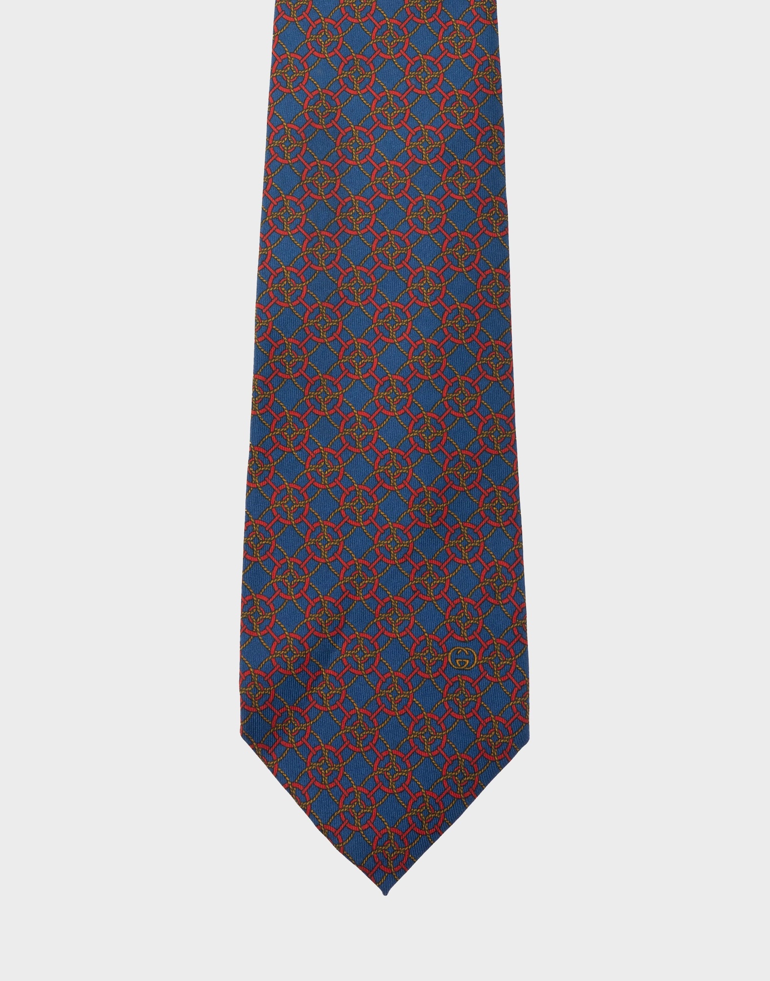 blue silk tie with red geometric pattern and gold-coloured braided cord