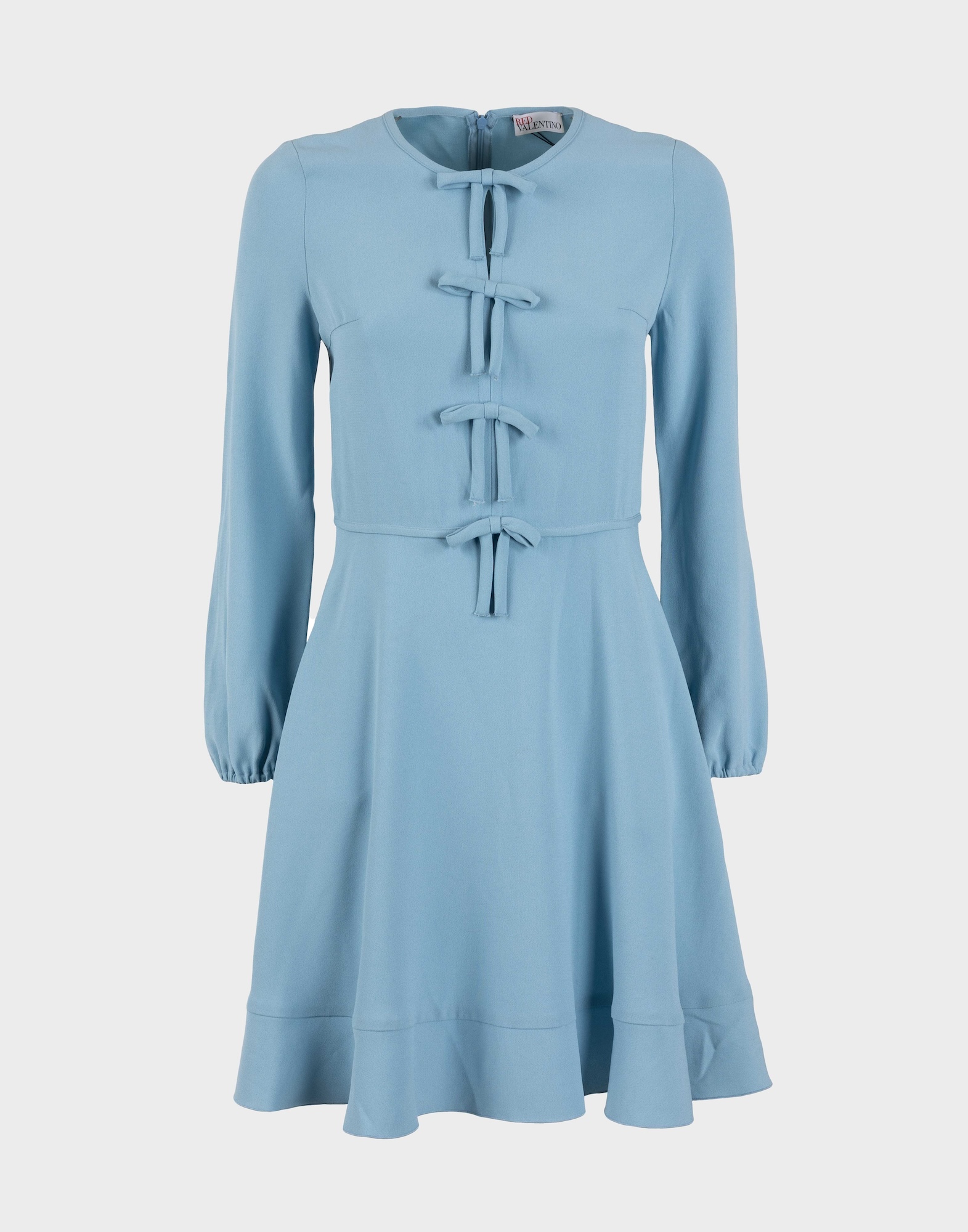light blue long-sleeved women's dress with appliqué bows