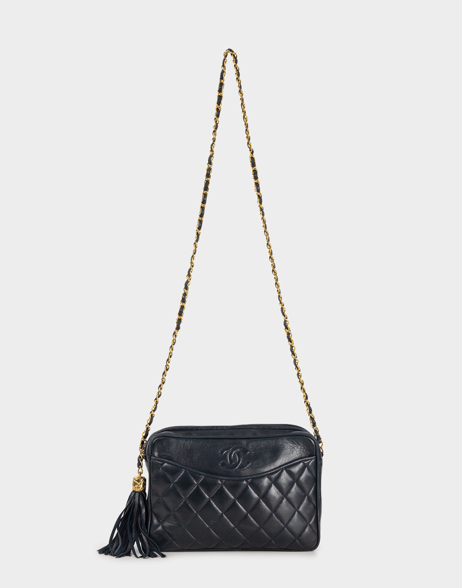 blue 80s quilted lambskin chanel bag with gold chain and pom pom on the side