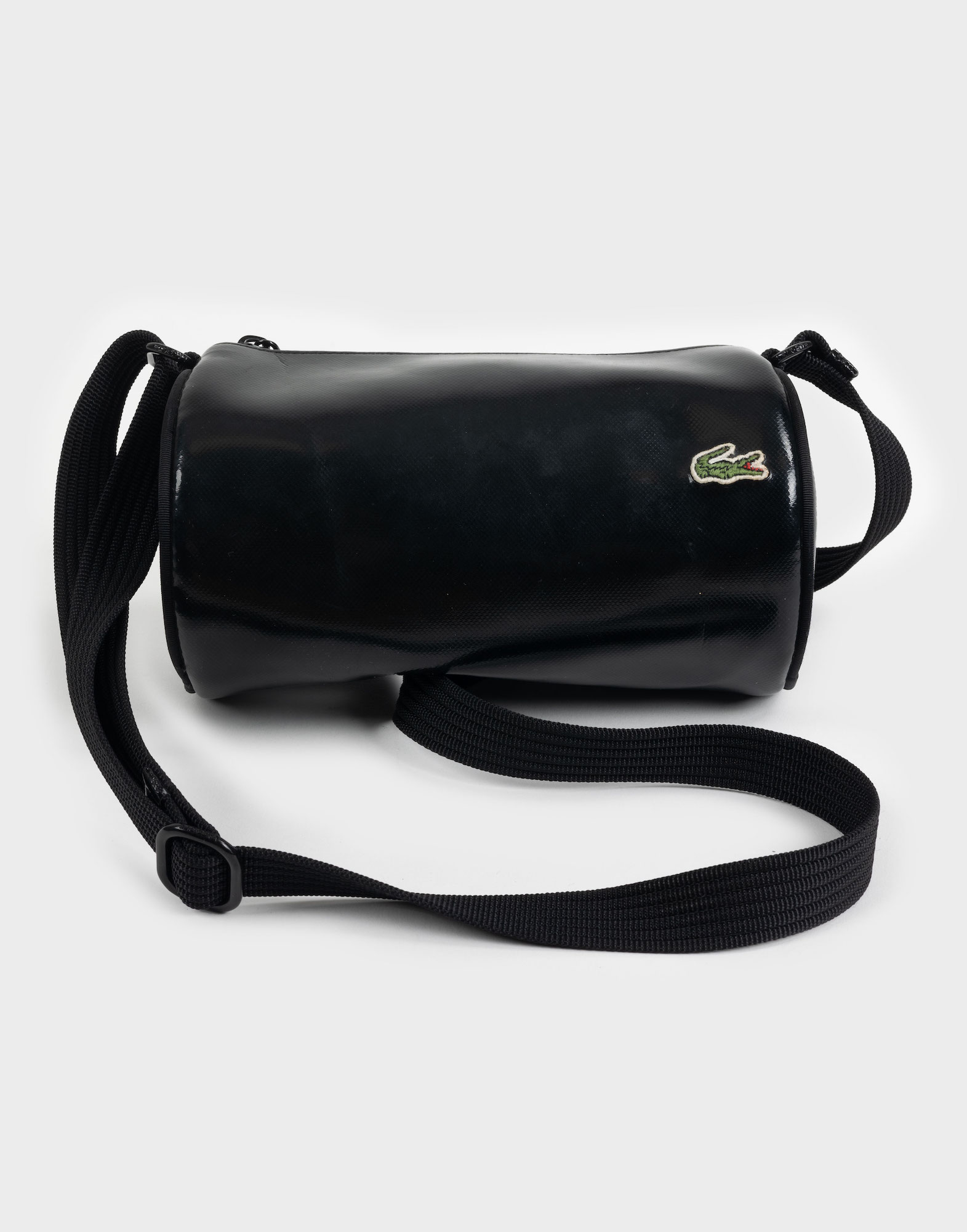 black oval lacoste bag with adjustable fabric shoulder strap