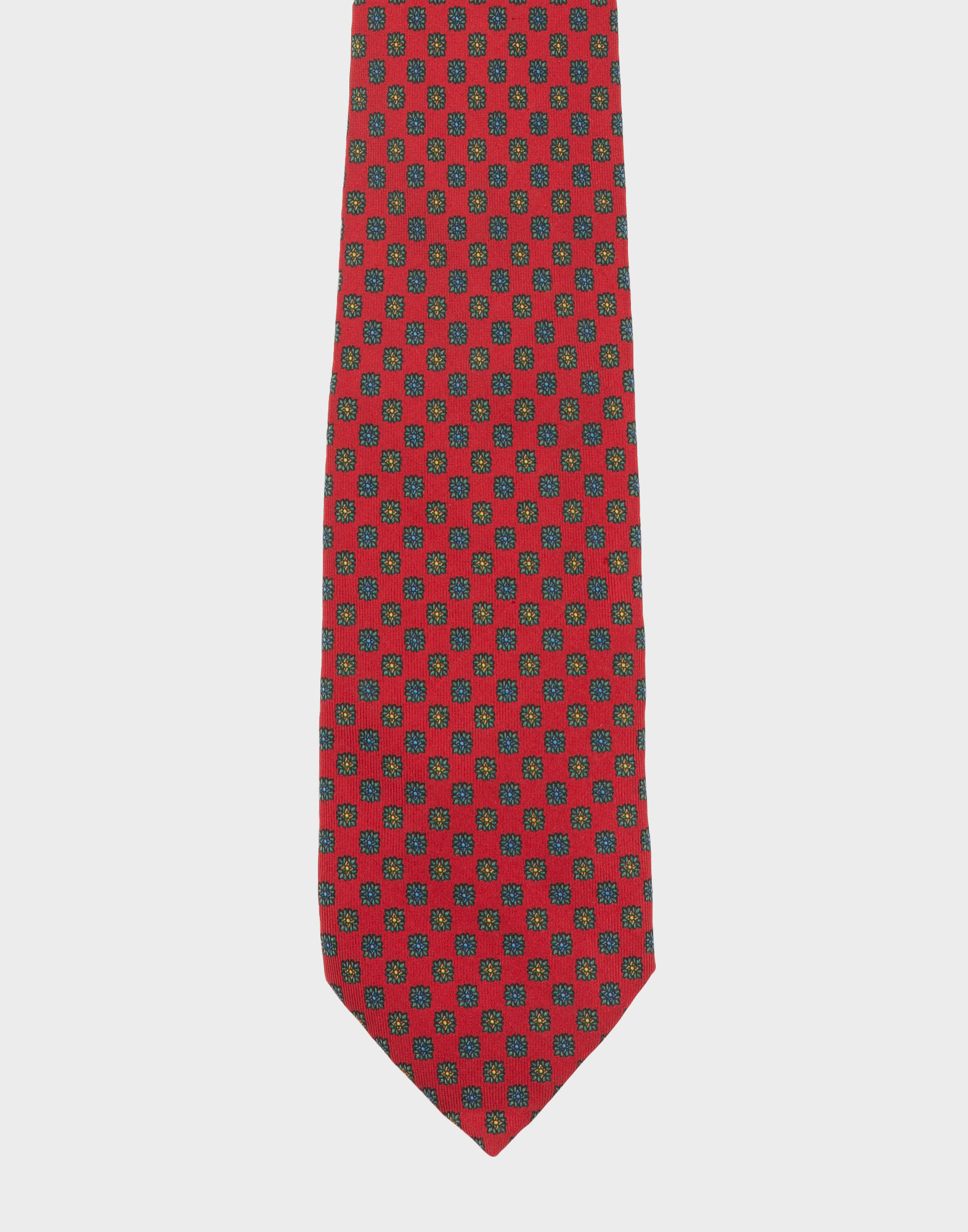 Red silk tie by E. Marinella featuring a multicolored micro-floral pattern.