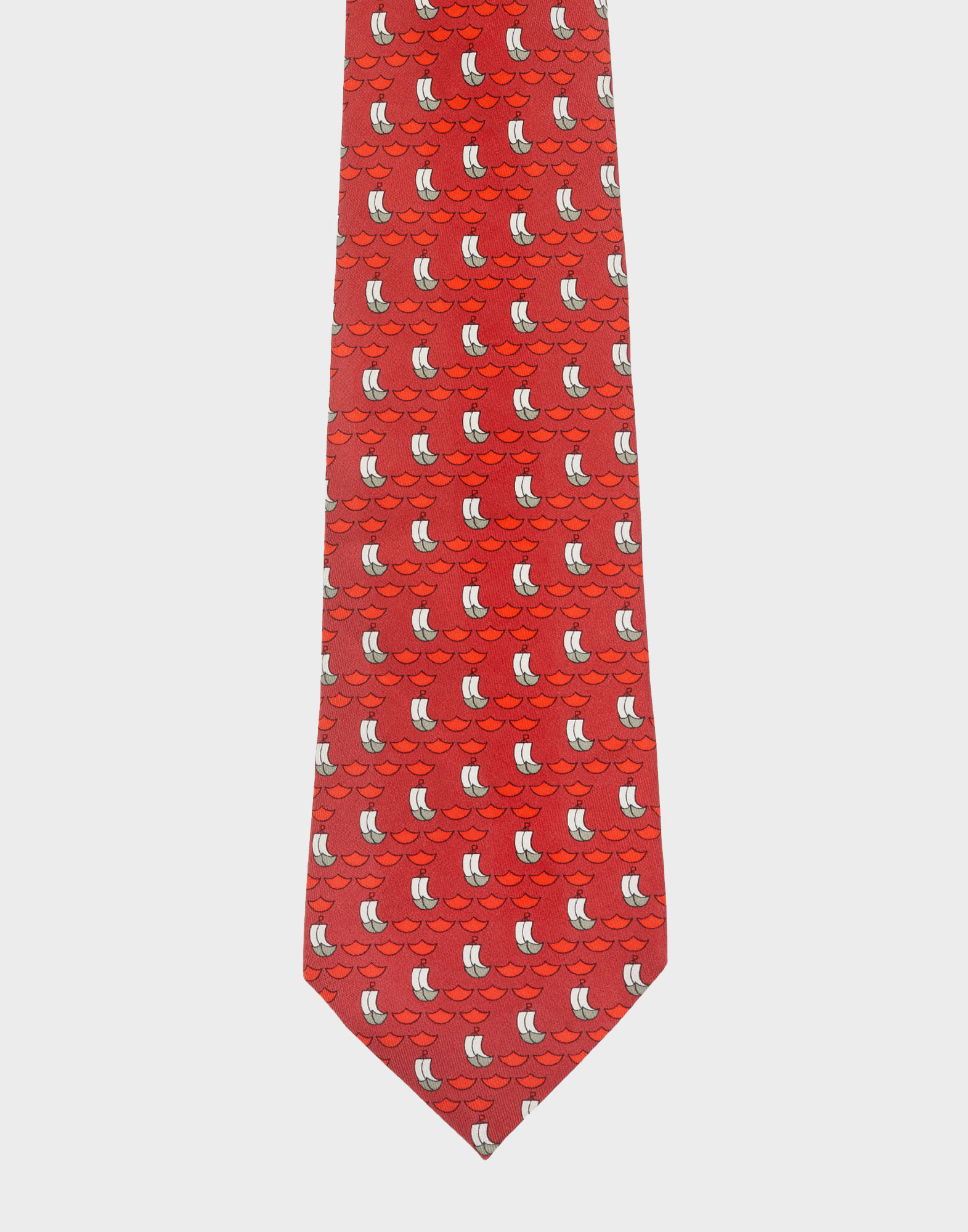 Red silk Hermès tie with a diagonal sailboat pattern