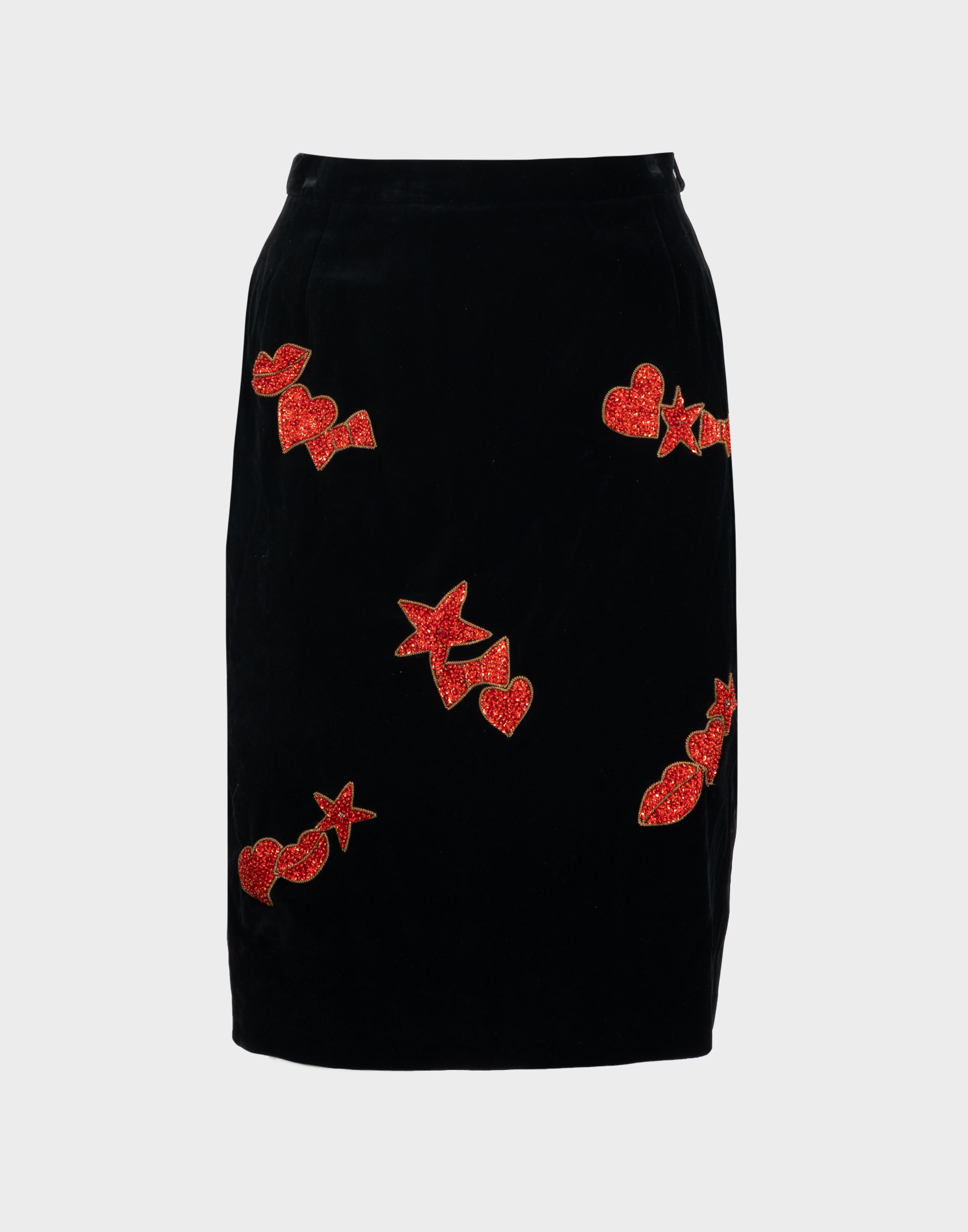 **High-waisted black velvet women's skirt with a pattern of red hearts, bows, and stars adorned with sequins.**